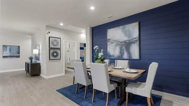 a kitchen with refrigerator and cabinets