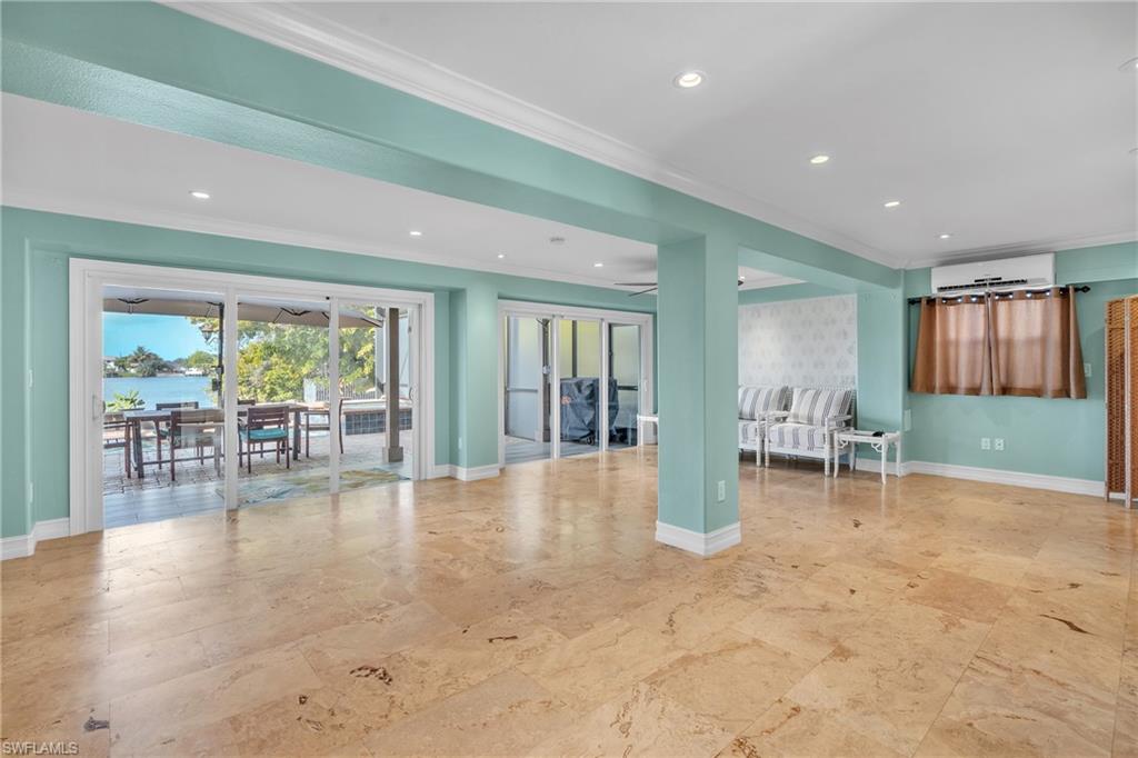 3001 50th Street Southwest Naples, FL 34116 - Photo 11 of 46 a view of an empty room with furniture and floor to ceiling window