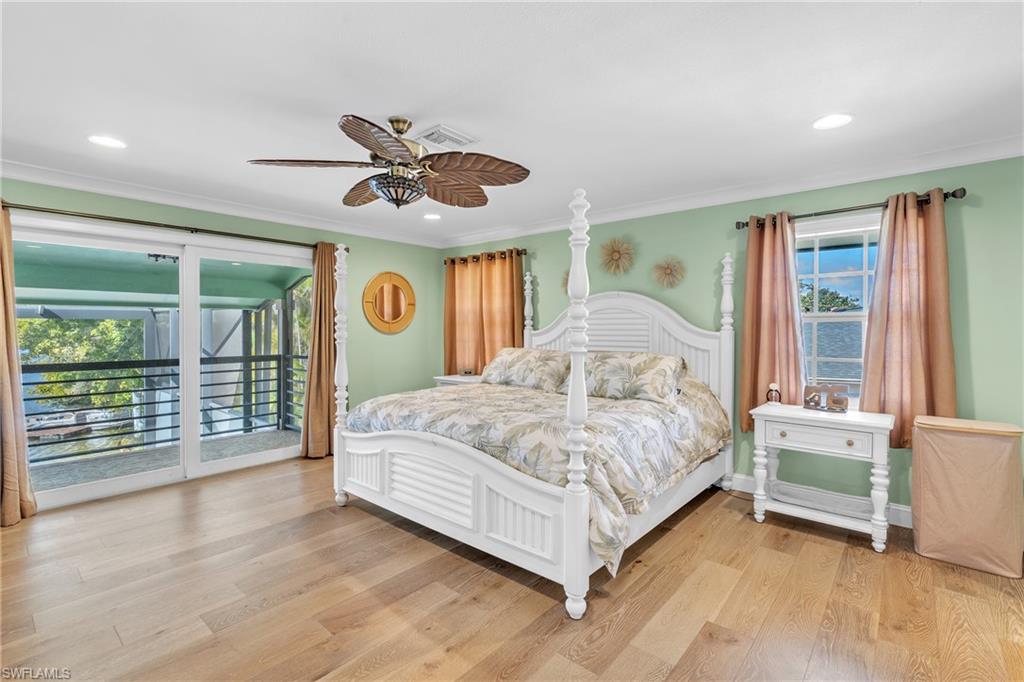 3001 50th Street Southwest Naples, FL 34116 - Photo 12 of 46 a bedroom with a large bed and a chandelier