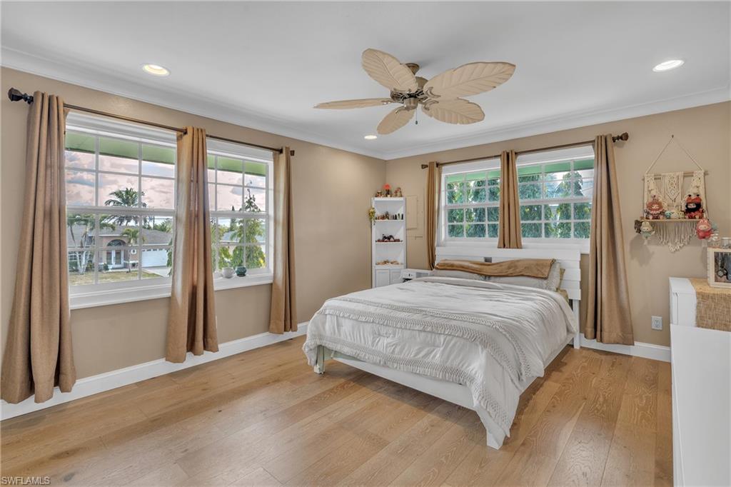 3001 50th Street Southwest Naples, FL 34116 - Photo 18 of 46 a bedroom with a large bed and a large window
