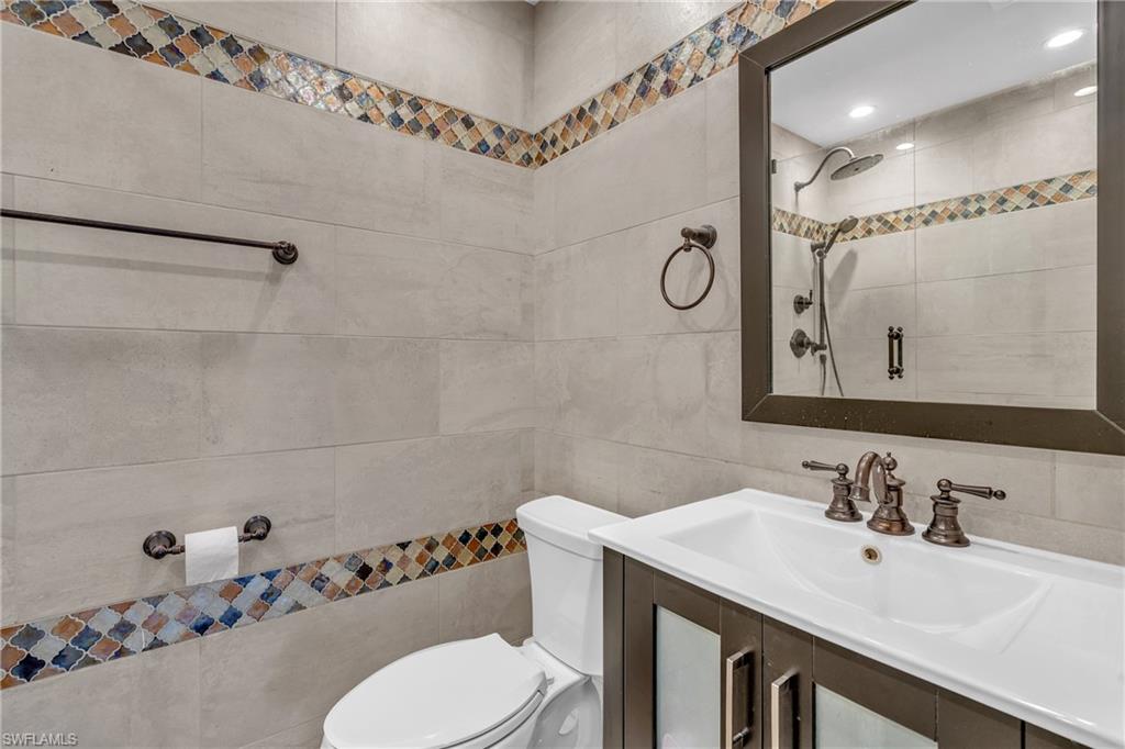 3001 50th Street Southwest Naples, FL 34116 - Photo 21 of 46 a bathroom with a sink vanity mirror and toilet