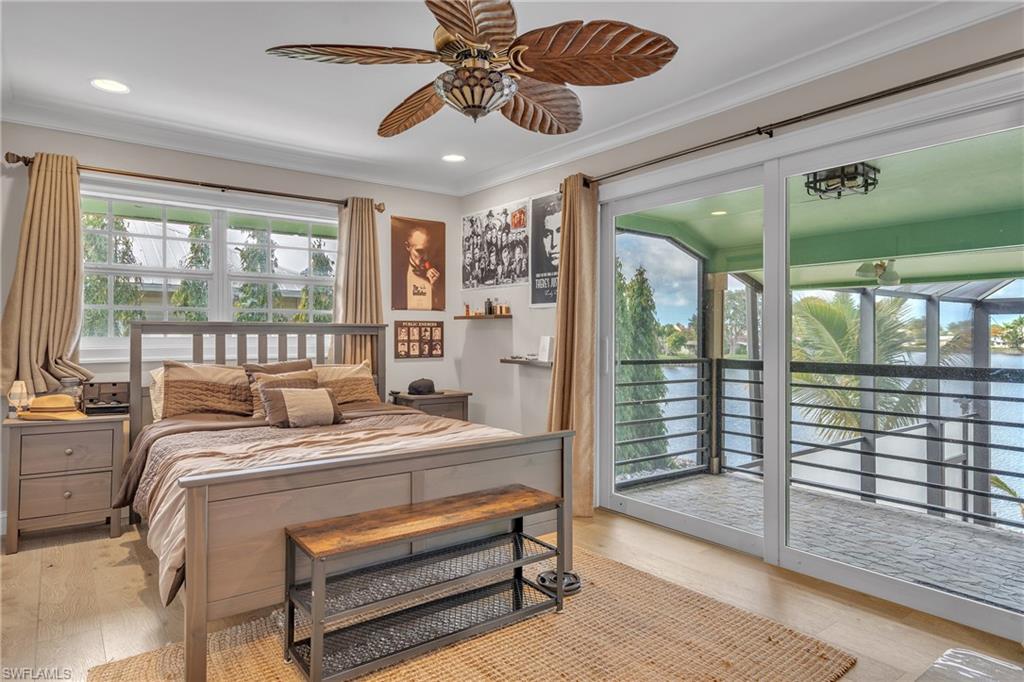 3001 50th Street Southwest Naples, FL 34116 - Photo 22 of 46 a bedroom with a bed and large window