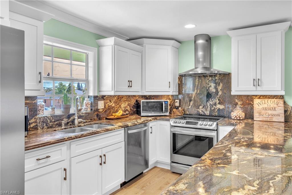 3001 50th Street Southwest Naples, FL 34116 - Photo 3 of 46 a kitchen with stainless steel appliances granite countertop a stove sink and cabinets