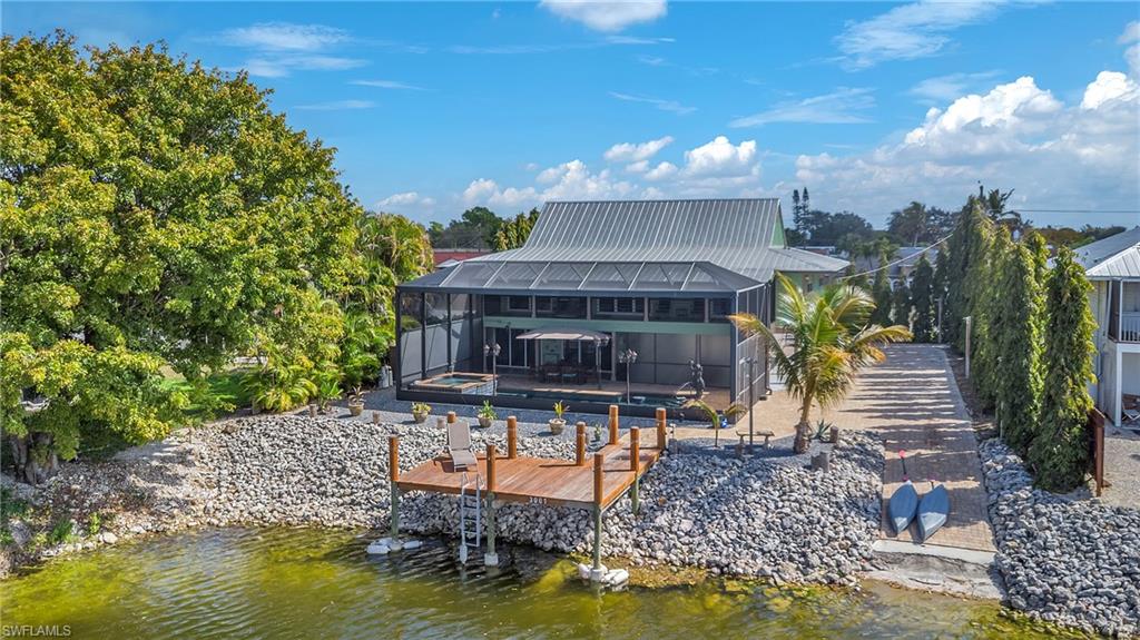 3001 50th Street Southwest Naples, FL 34116 - Photo 32 of 46 a swimming pool view with a seating space