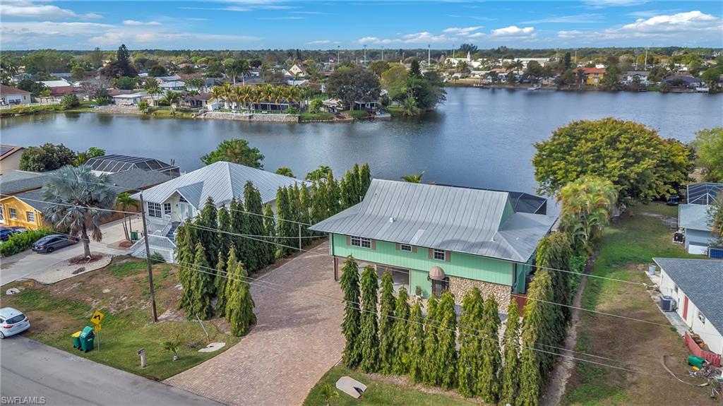 3001 50th Street Southwest Naples, FL 34116 - Photo 34 of 46 an aerial view of a house with a yard and lake view