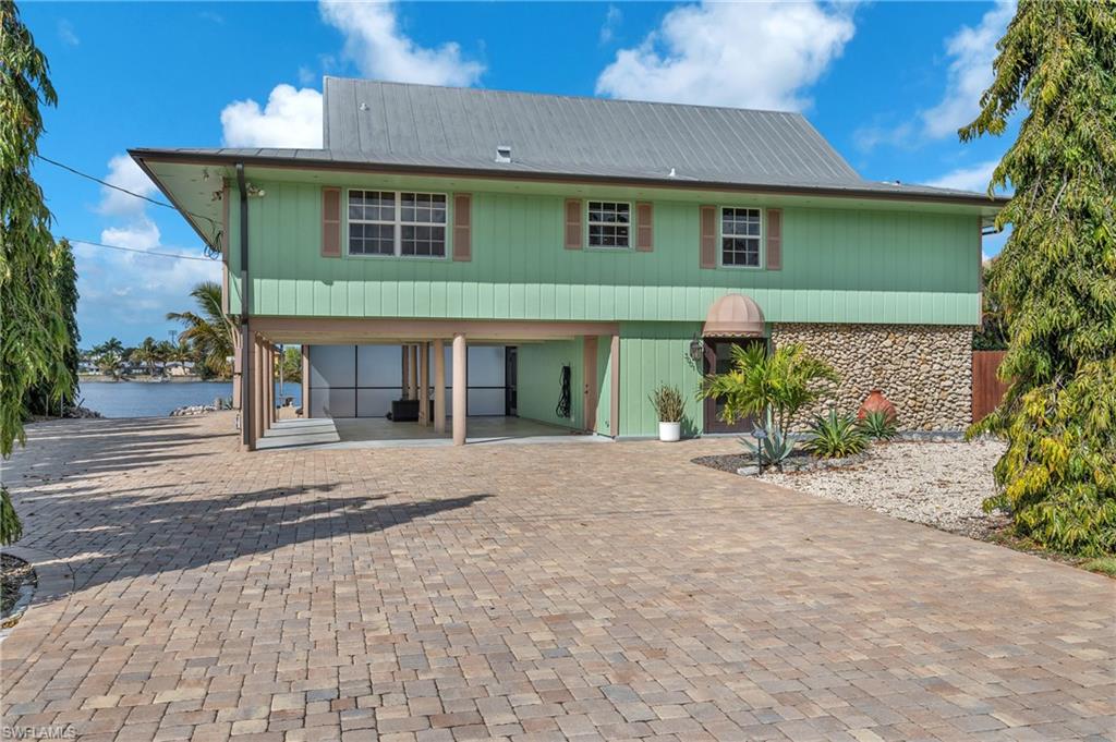 3001 50th Street Southwest Naples, FL 34116 - Photo 39 of 46 a front view of a house with a yard and a garage