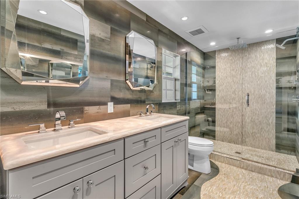 3001 50th Street Southwest Naples, FL 34116 - Photo 8 of 46 a spacious bathroom with a double vanity sink toilet and shower