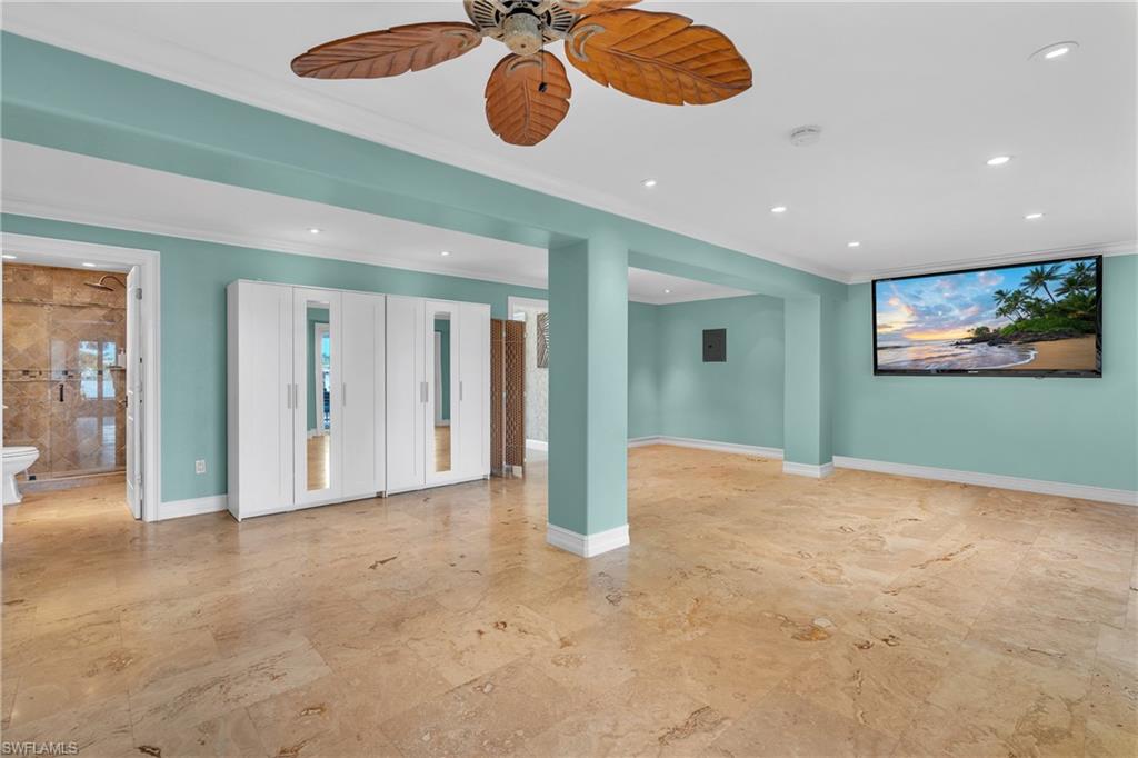 3001 50th Street Southwest Naples, FL 34116 - Photo 10 of 46 a view of an empty room and a chandelier fan