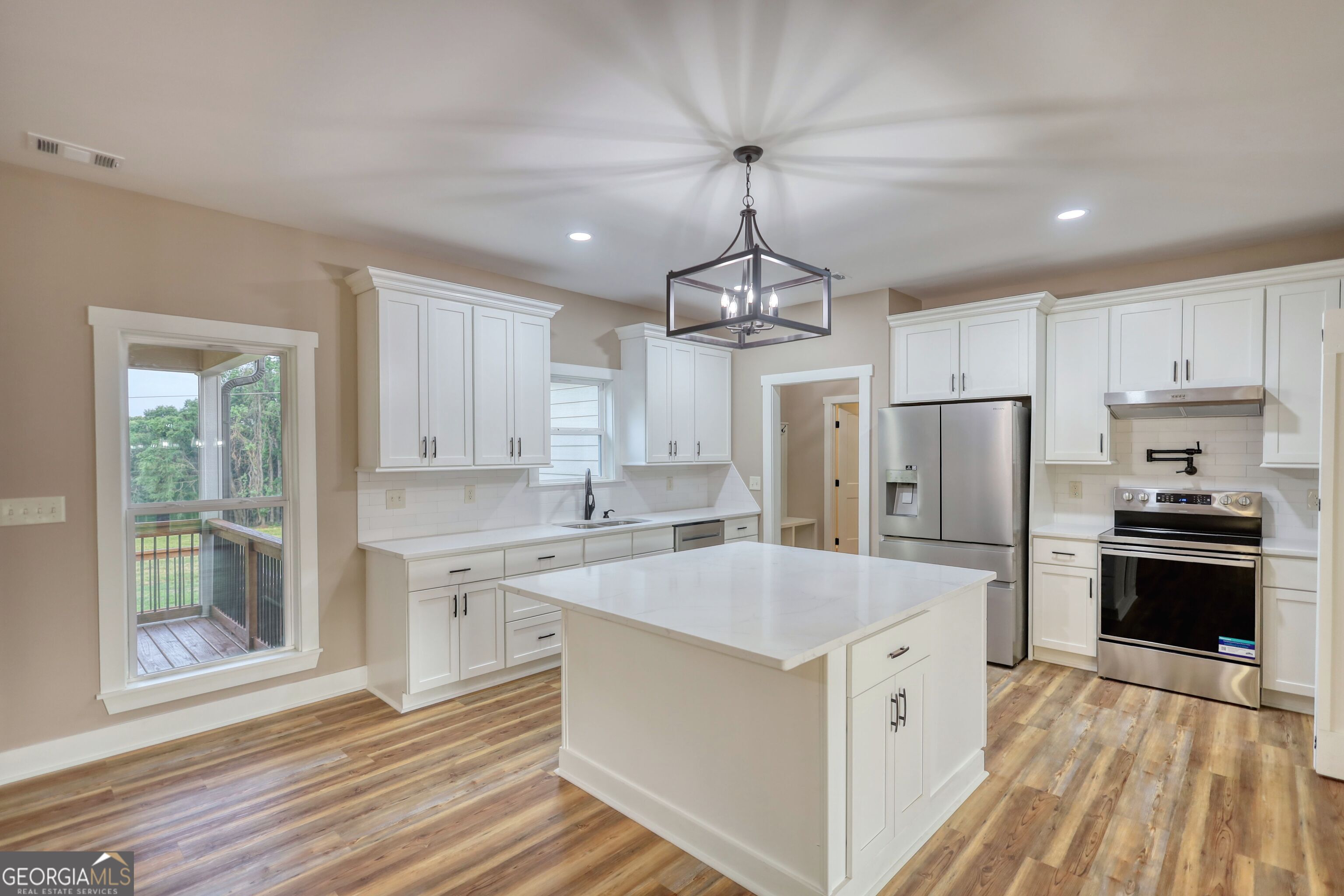 2941 Old Buckhead Road Madison, GA 30650 - Photo 13 of 58 a kitchen with stainless steel appliances granite countertop a sink stove and refrigerator