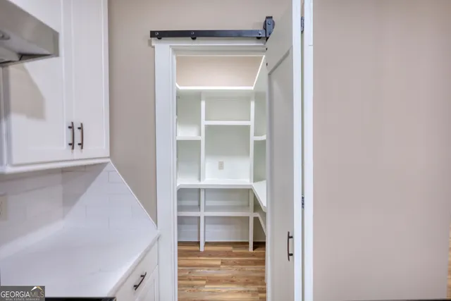 a view of walk in closet with empty room