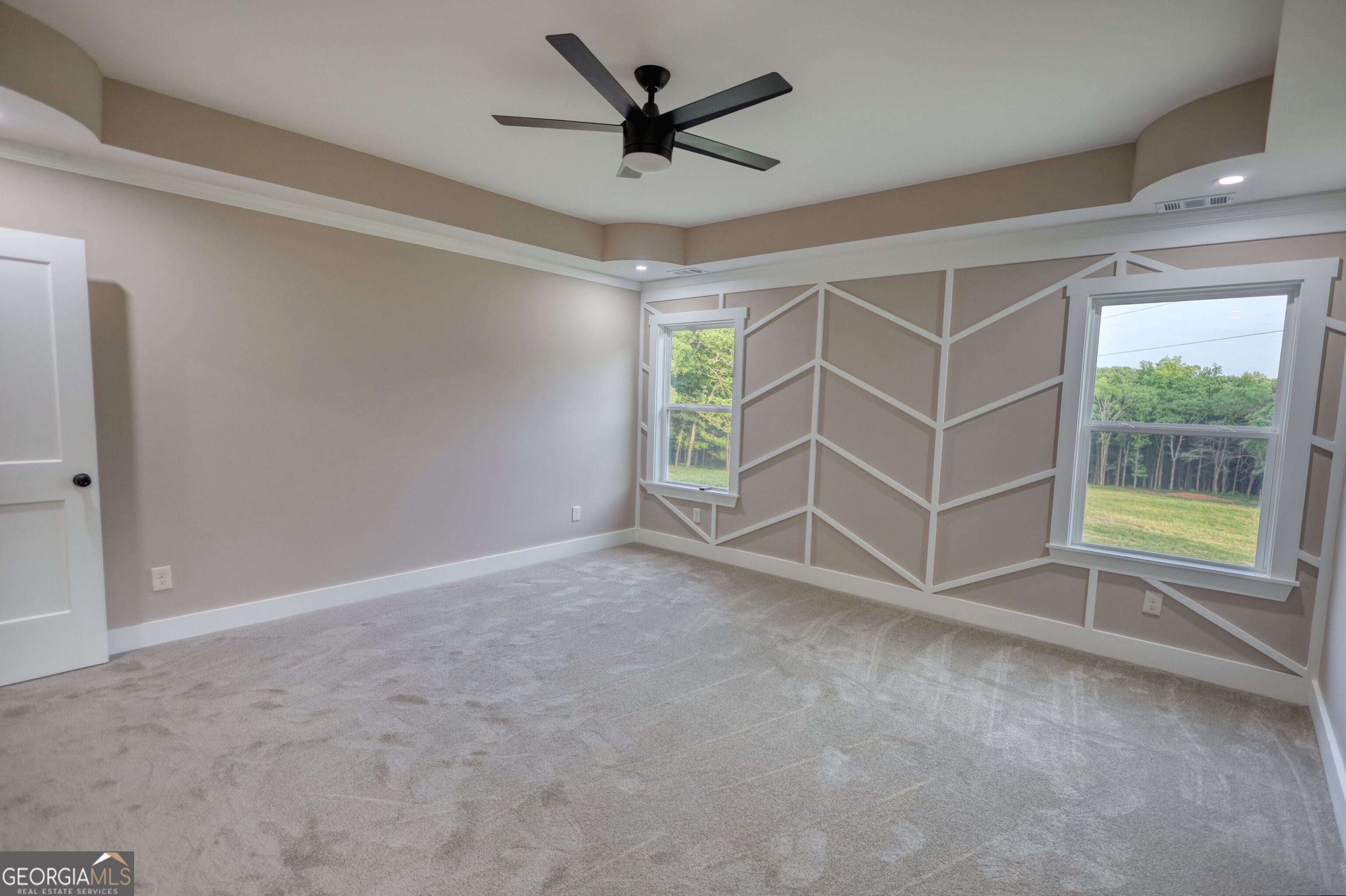 2941 Old Buckhead Road Madison, GA 30650 - Photo 30 of 58 an empty room with windows and ceiling fan