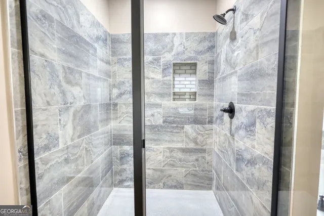 a bathroom with a bathtub and a shower