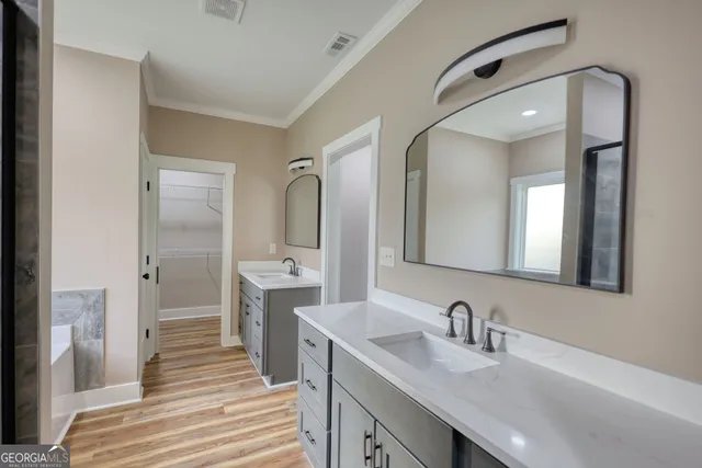 a view of an empty room with a chandelier fan