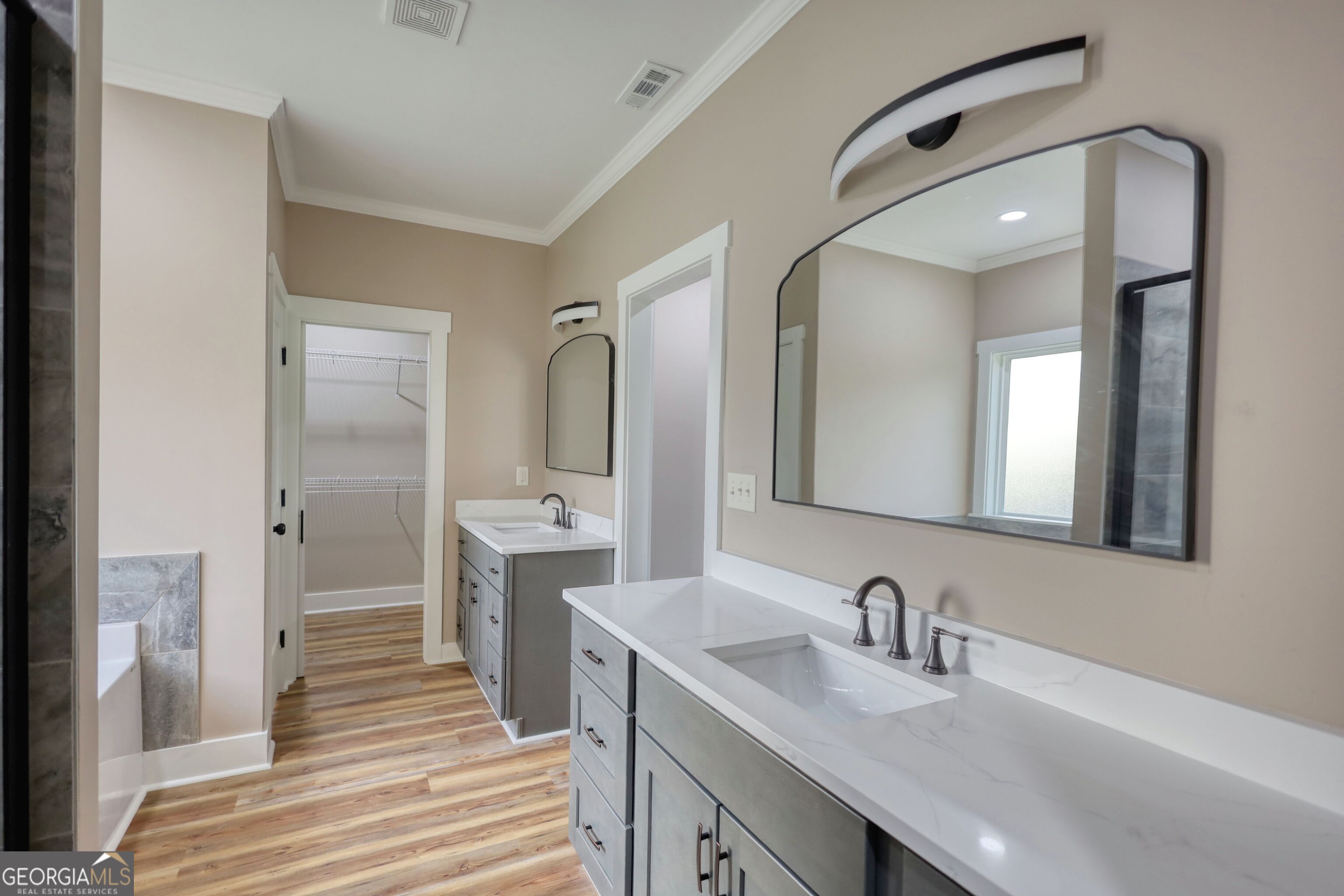 2941 Old Buckhead Road Madison, GA 30650 - Photo 40 of 58 a bathroom with double vanity sink and a mirror