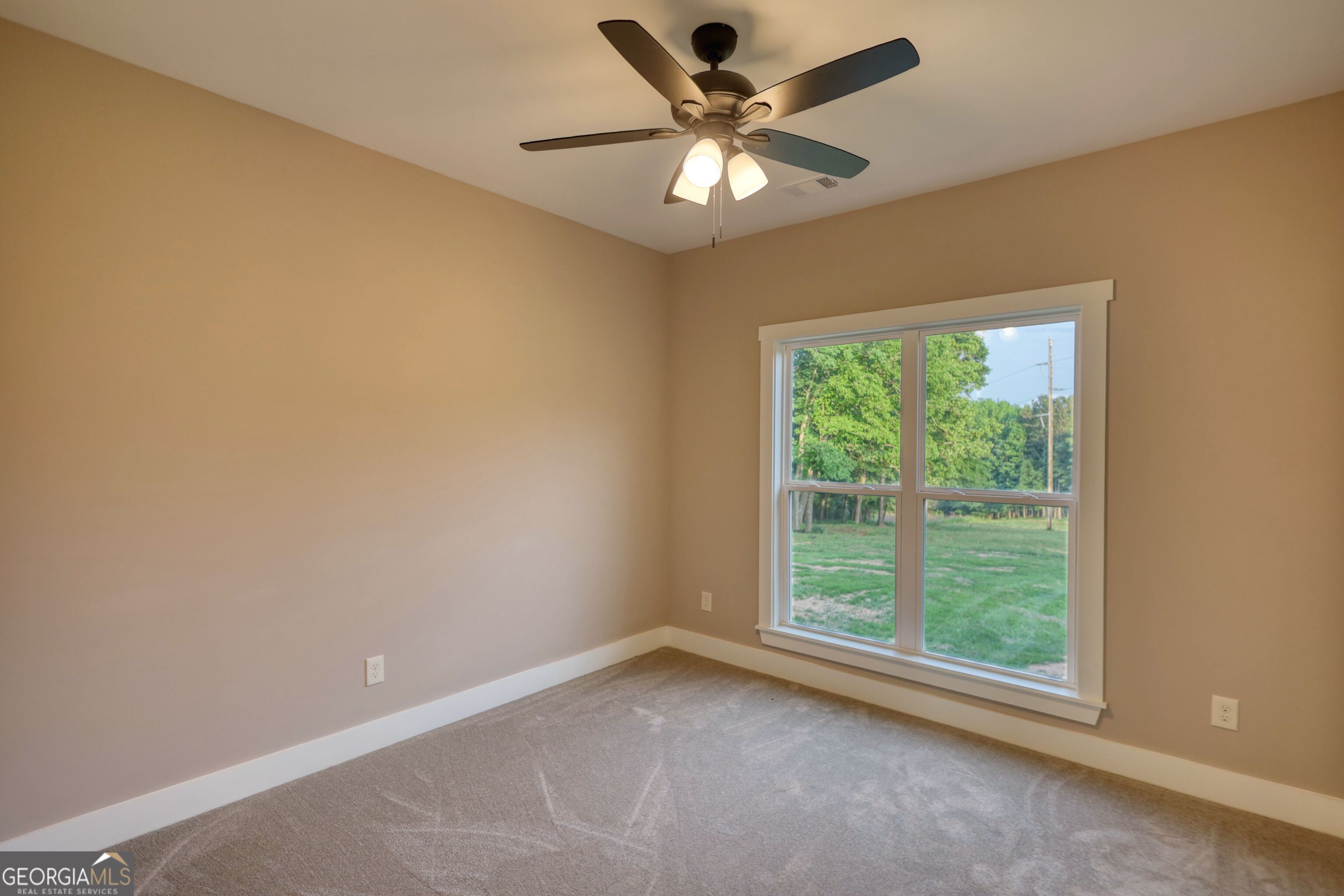 2941 Old Buckhead Road Madison, GA 30650 - Photo 42 of 58 a view of a big room with windows and chandelier fan