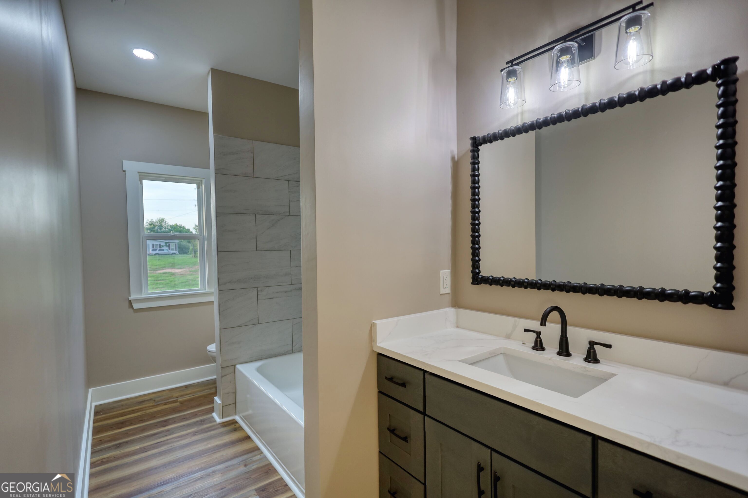 2941 Old Buckhead Road Madison, GA 30650 - Photo 45 of 58 a en suite bathroom with a double vanity sink a mirror and a shower