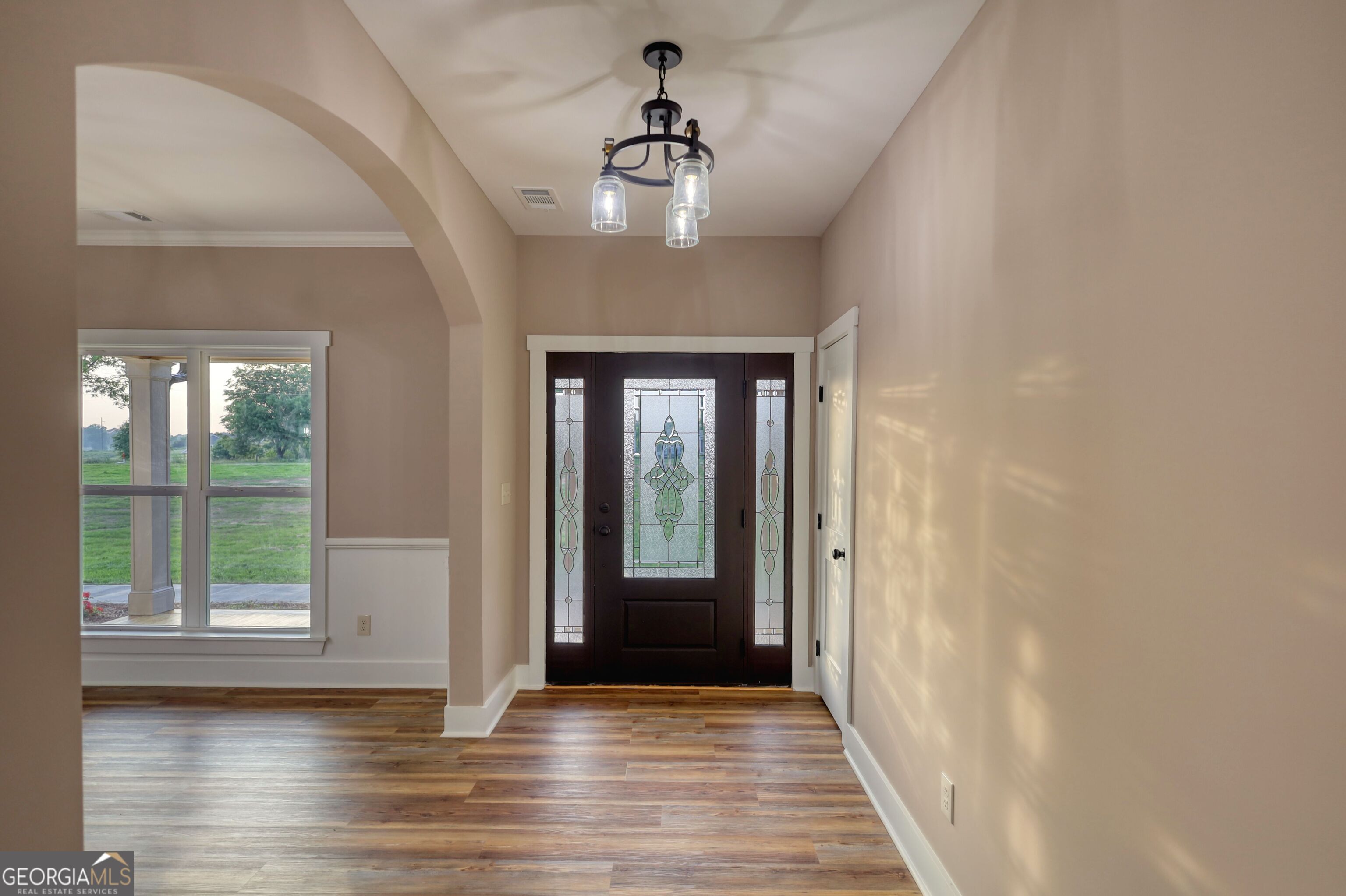 2941 Old Buckhead Road Madison, GA 30650 - Photo 7 of 58 a view of a hallway with wooden floor and a chandelier