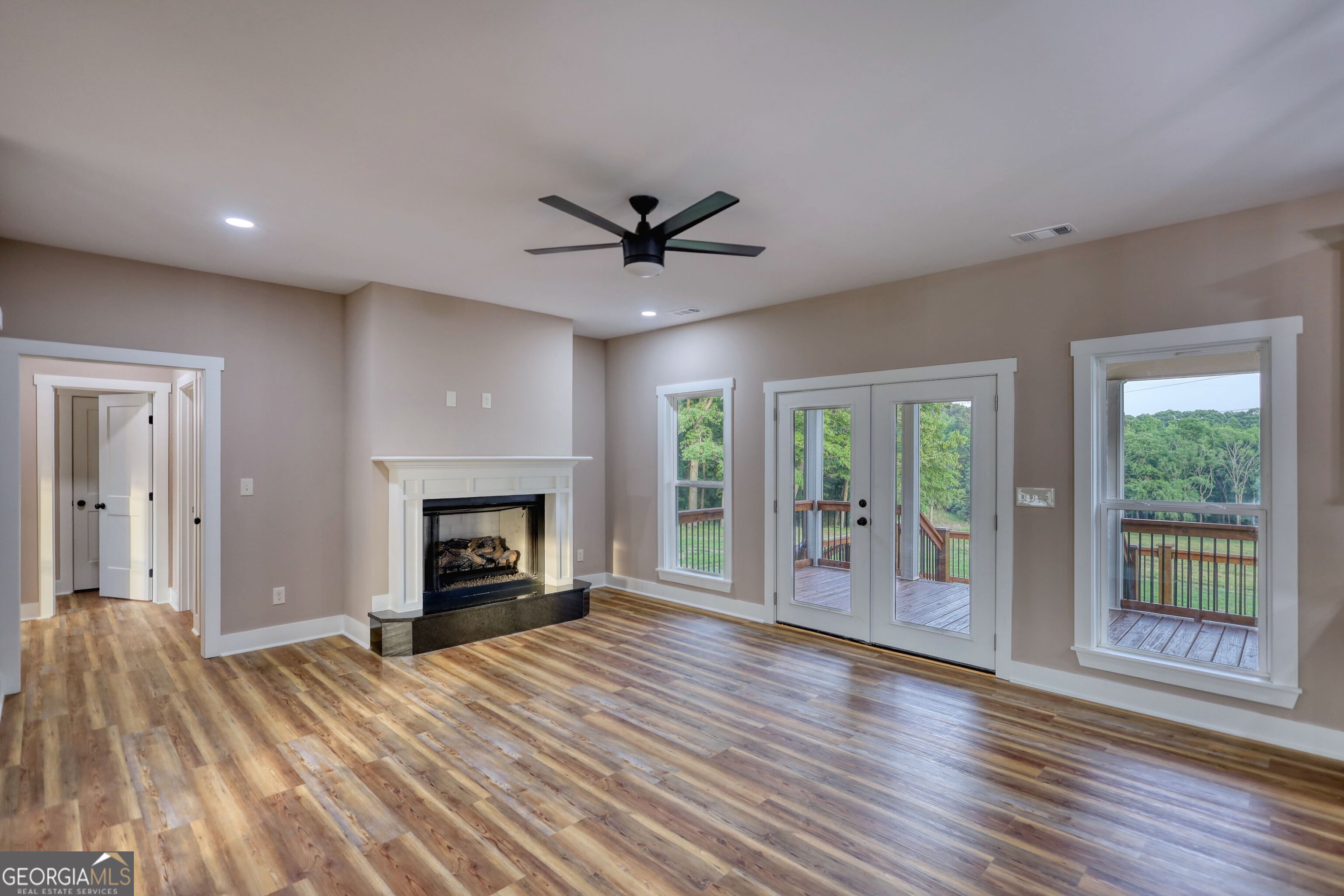 2941 Old Buckhead Road Madison, GA 30650 - Photo 8 of 58 a view of an empty room with a fireplace and a window