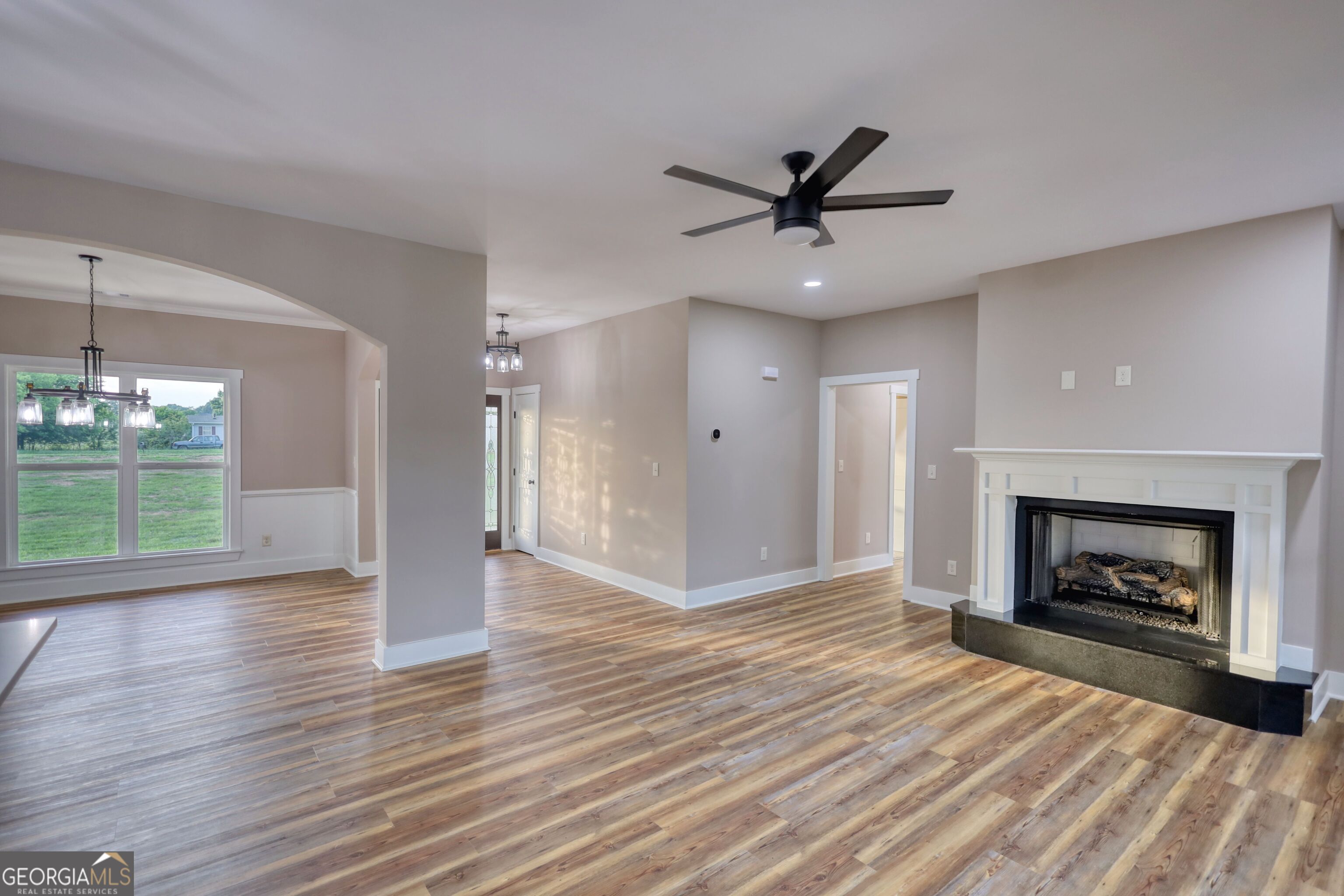 2941 Old Buckhead Road Madison, GA 30650 - Photo 10 of 58 a view of an empty room with wooden floor fireplace and a window