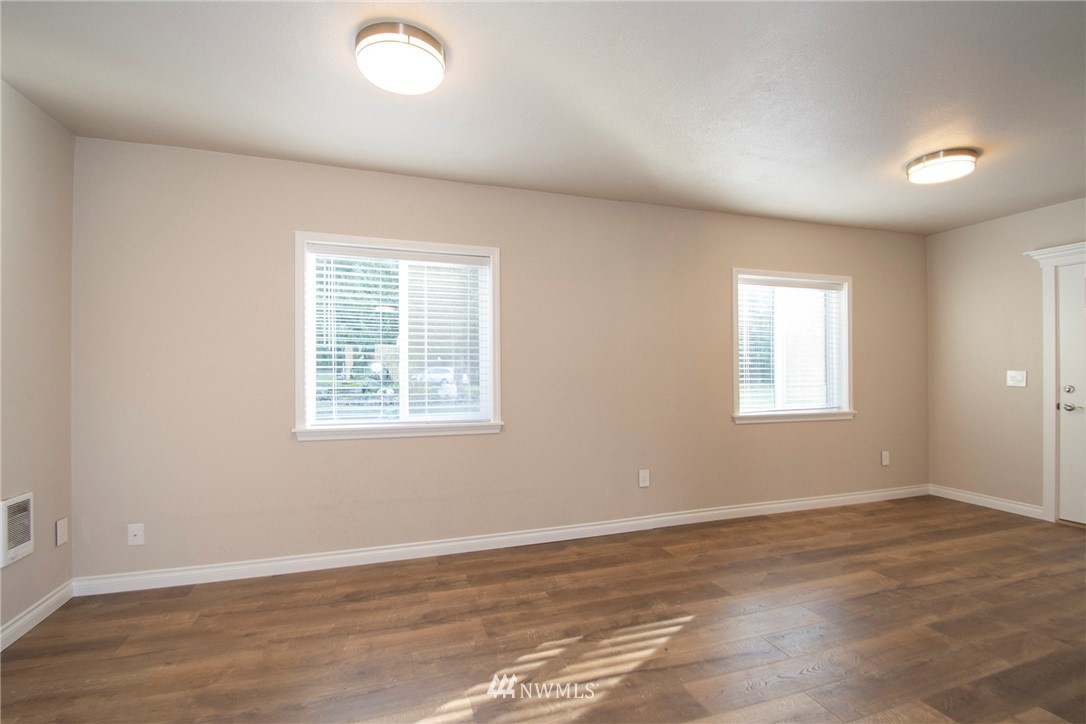 15941 Littlerock Road Southwest Rochester, WA 98579 - Photo 14 of 31 an empty room with wooden floor and windows