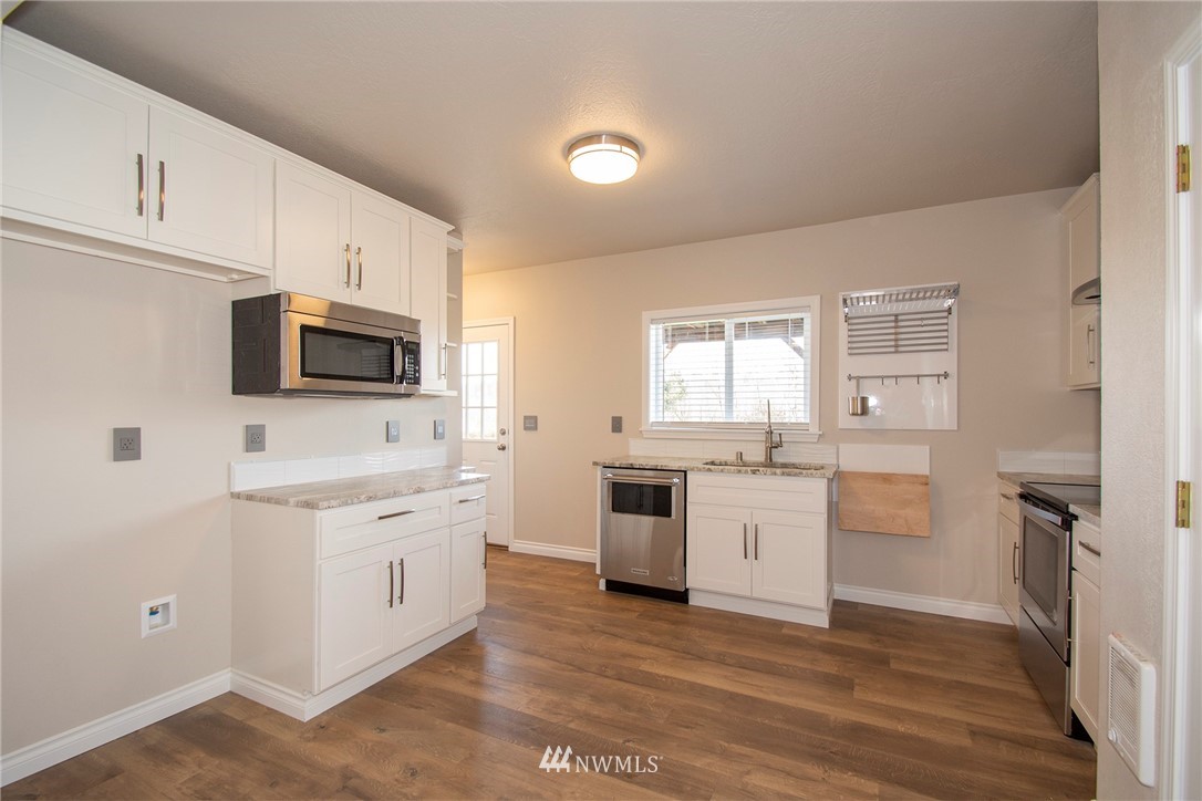 15941 Littlerock Road Southwest Rochester, WA 98579 - Photo 16 of 31 a kitchen with a stove a sink and a microwave
