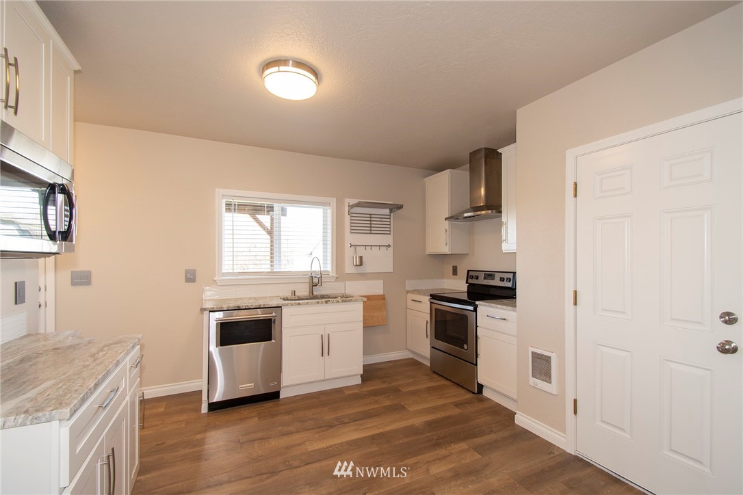 15941 Littlerock Road Southwest Rochester, WA 98579 - Photo 17 of 31 a kitchen with stainless steel appliances granite countertop a stove and a sink