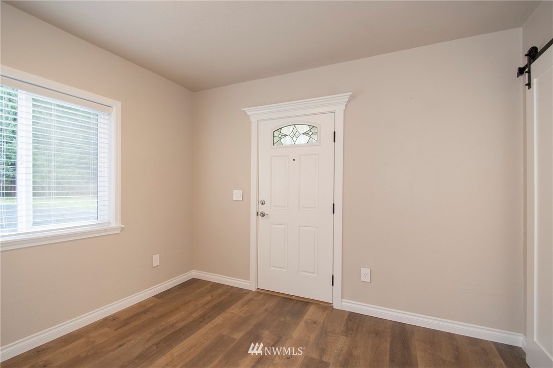 15941 Littlerock Road Southwest Rochester, WA 98579 - Photo 10 of 31 a view of an empty room with wooden floor and a window