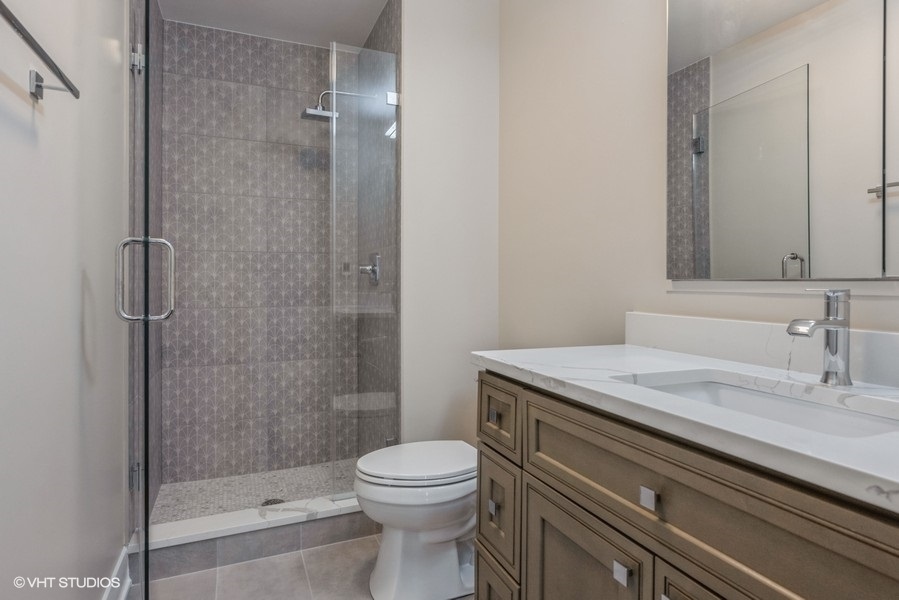 6033 North Sheridan Road, Unit 5D Chicago, IL 60660 - Photo 11 of 11 a bathroom with a granite countertop sink a toilet and shower