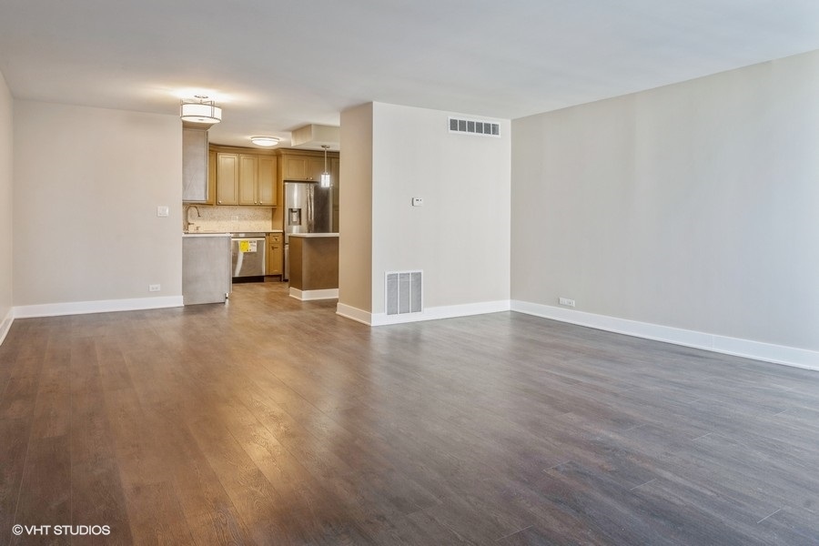 6033 North Sheridan Road, Unit 5D Chicago, IL 60660 - Photo 5 of 11 a view of a kitchen with a sink and a refrigerator