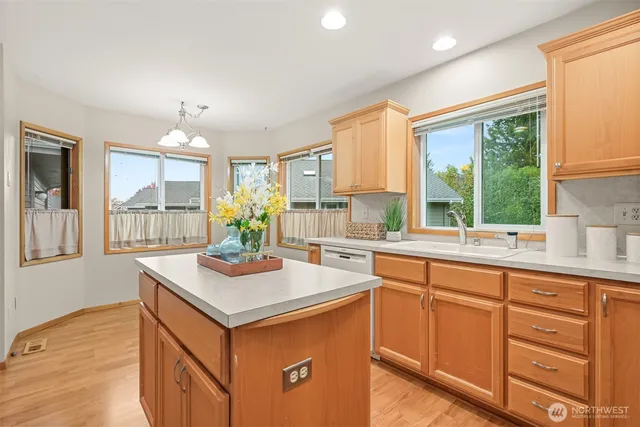 a kitchen with sink cabinets and wooden floor