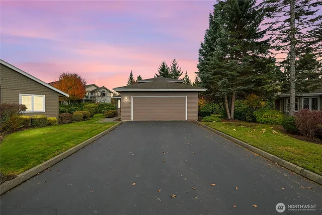 a front view of a house with a yard and a garage