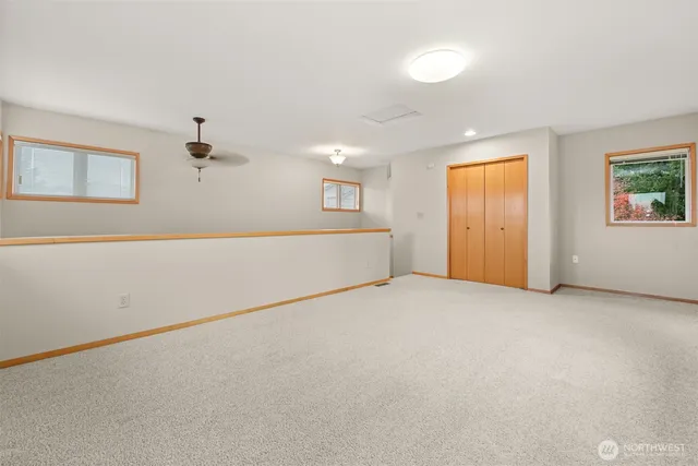 an empty room with windows and closet