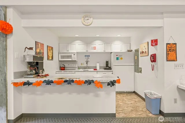 a white kitchen with table and chairs