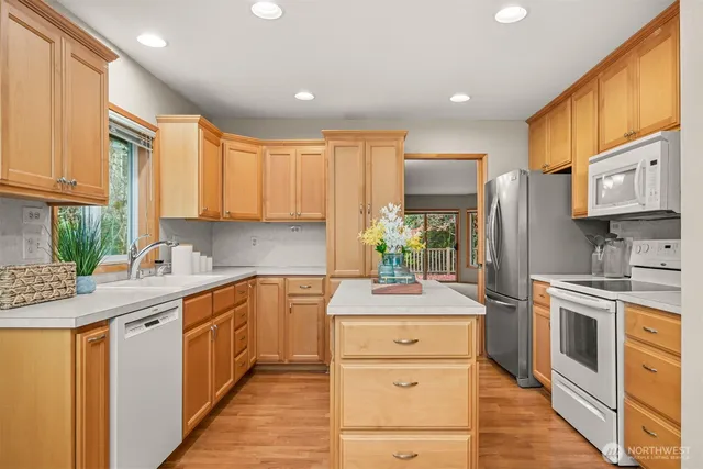 a kitchen with a sink stove and refrigerator