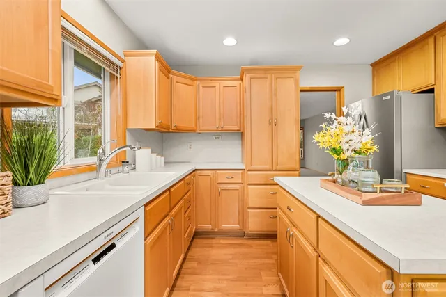 a kitchen with stainless steel appliances granite countertop sink stove and refrigerator
