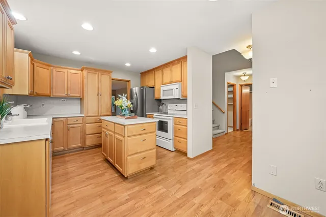 a kitchen with white cabinets and stainless steel appliances
