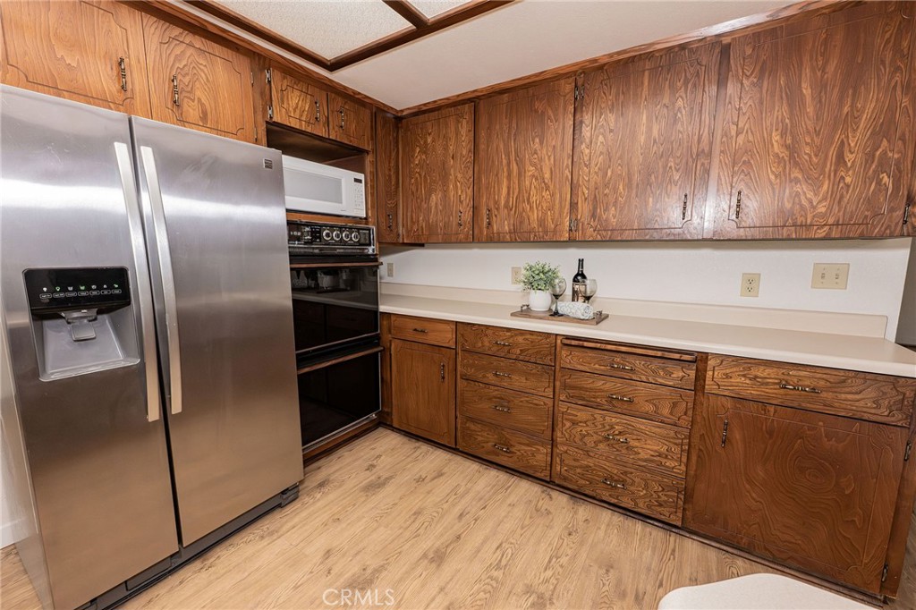 329 Byron Way Orland, CA 95963 - Photo 13 of 35 a kitchen with stainless steel appliances granite countertop a refrigerator a sink a stove with wooden cabinets