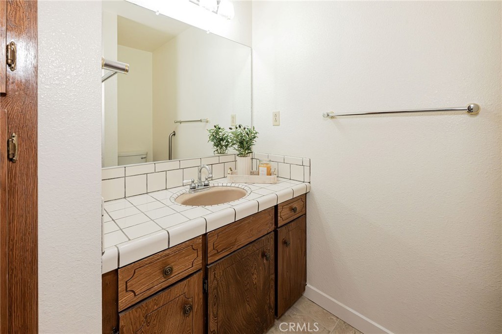 329 Byron Way Orland, CA 95963 - Photo 29 of 35 a bathroom with a sink and a mirror