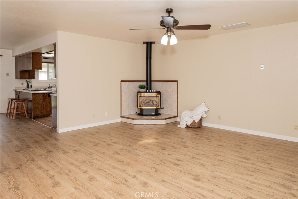 329 Byron Way Orland, CA 95963 - Photo 4 of 35 a view of a room with wooden floor ceiling fan and window
