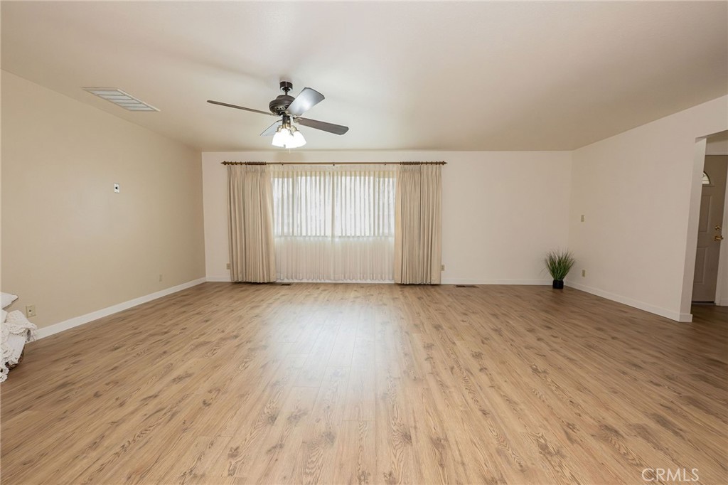 329 Byron Way Orland, CA 95963 - Photo 7 of 35 an empty room with wooden floor ceiling fan and windows