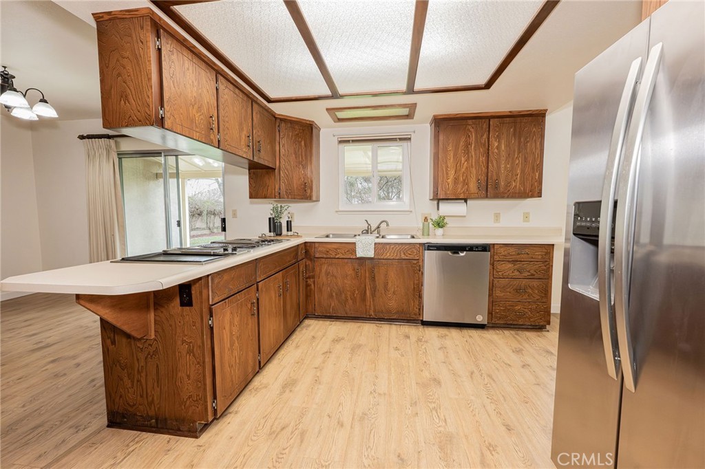 329 Byron Way Orland, CA 95963 - Photo 10 of 35 a kitchen with stainless steel appliances granite countertop a sink a counter space and cabinets
