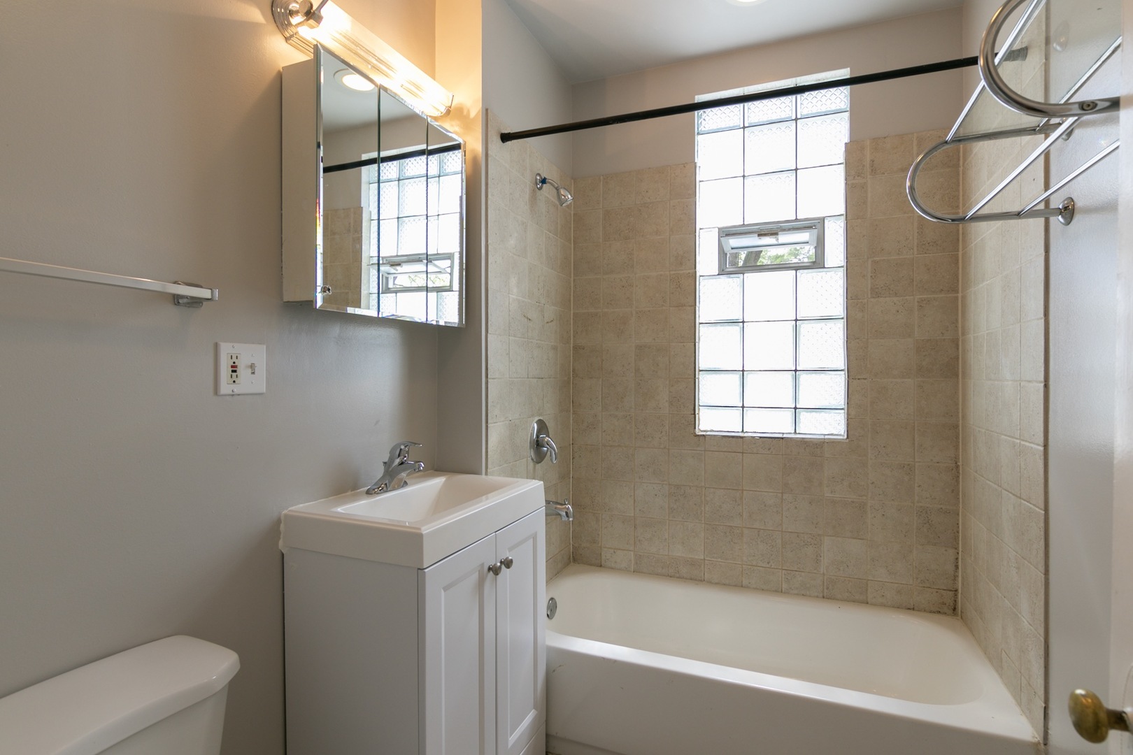 4101 North Bell Avenue, Unit 2 Chicago, IL 60618 - Photo 8 of 16 a white bath tub sitting next to a white toilet and a window