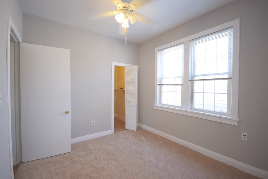 4101 North Bell Avenue, Unit 2 Chicago, IL 60618 - Photo 10 of 16 an empty room with chandelier fan and windows