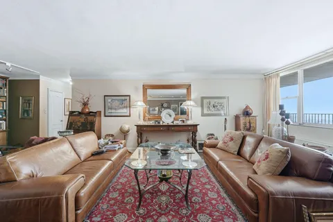 a living room with furniture and a rug
