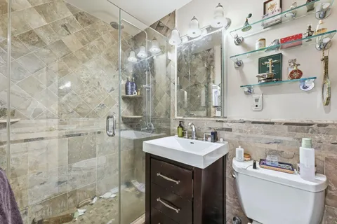 a bathroom with a sink vanity mirror and toilet