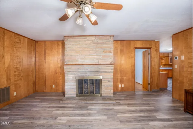 a view of a livingroom with a fireplace and wooden floor