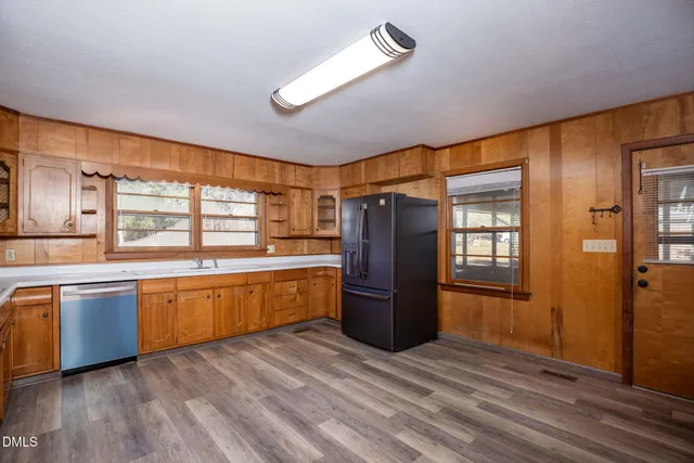 a kitchen with stainless steel appliances a refrigerator and a stove top oven