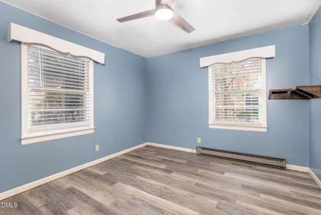 a bathroom with a granite countertop sink a mirror and a shower