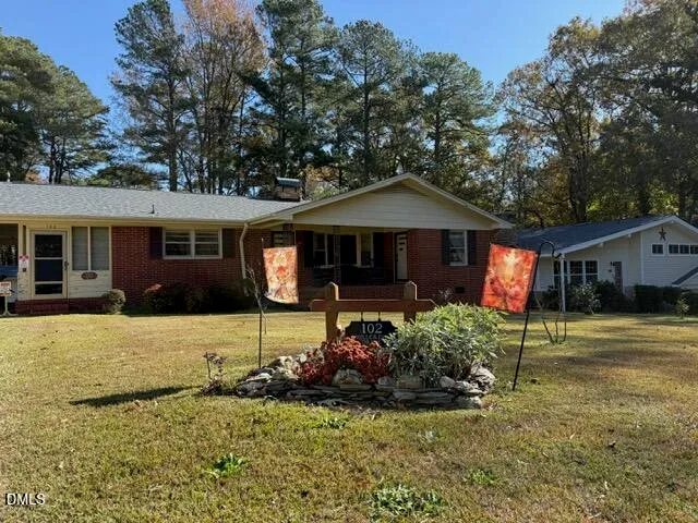 a front view of a house with a garden