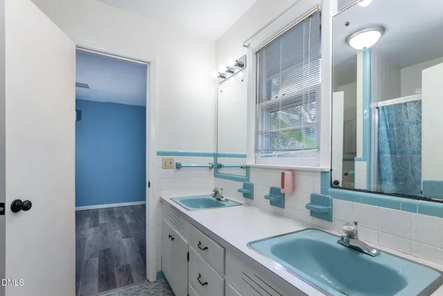 a view of an empty room with cabinet and a window